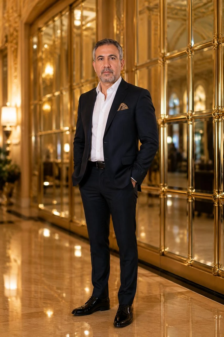 Mr Ahmet Akça, founder of MARSERA, standing in a gold mirrored interior